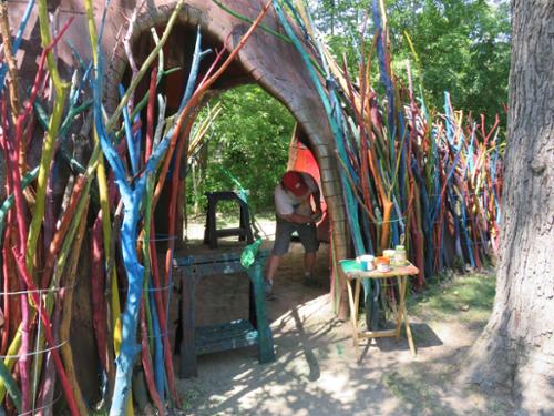 Installation of brightly colored painted sticks